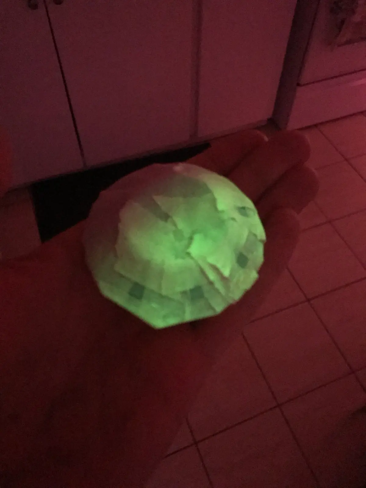 A mini UFO glowing in the dark