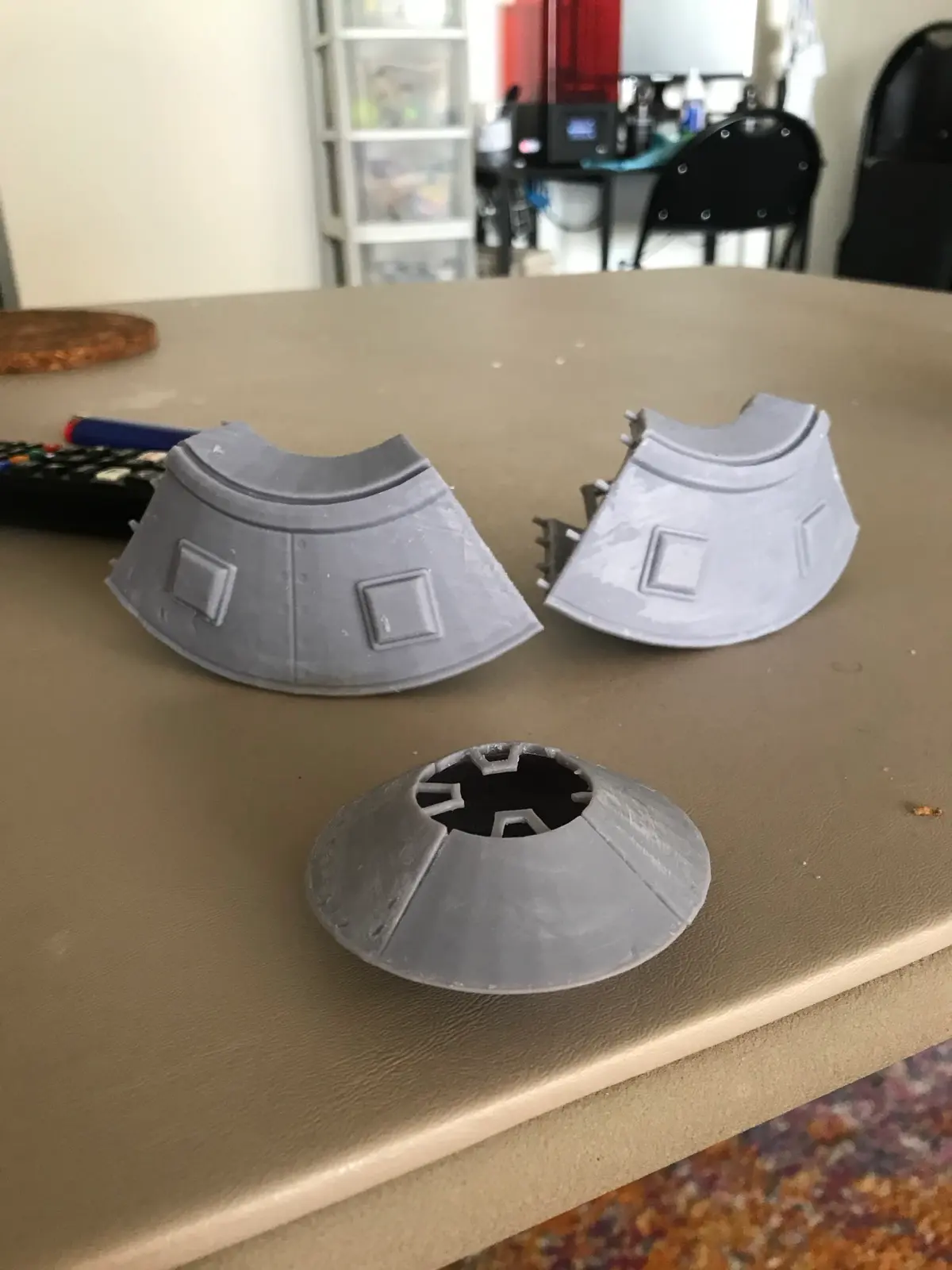 Full-size hull pieces next to the small resin test model